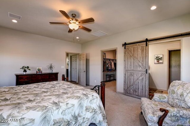 130 Brenna Dr, Chino Valley, AZ 86323 - bedroom with a barn door, carpet floors, a walk in closet, recessed lighting, and a ceiling fan