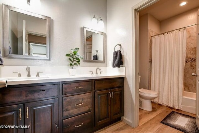 130 Brenna Dr, Chino Valley, AZ 86323 - bathroom with double vanity, toilet, wood finished floors, and shower / tub combo with curtain