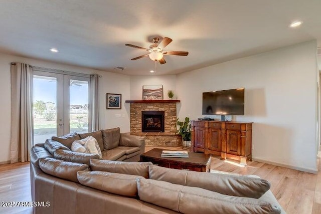 130 Brenna Dr, Chino Valley, AZ 86323 - living room with ceiling fan, light wood-style flooring, french doors, baseboards, and a stone fireplace