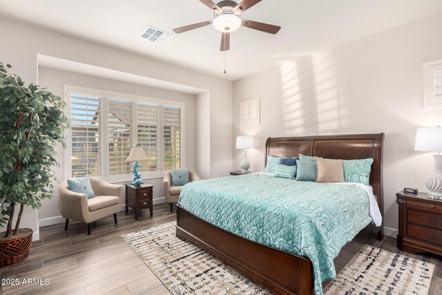bedroom featuring wood finished floors, baseboards, and ceiling fan