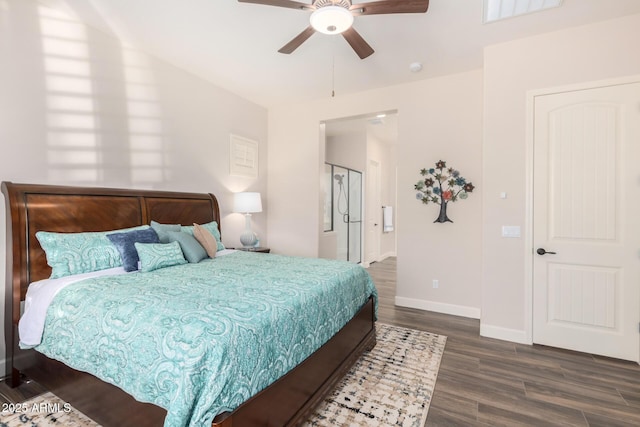 bedroom featuring wood finished floors, baseboards, a ceiling fan, and connected bathroom