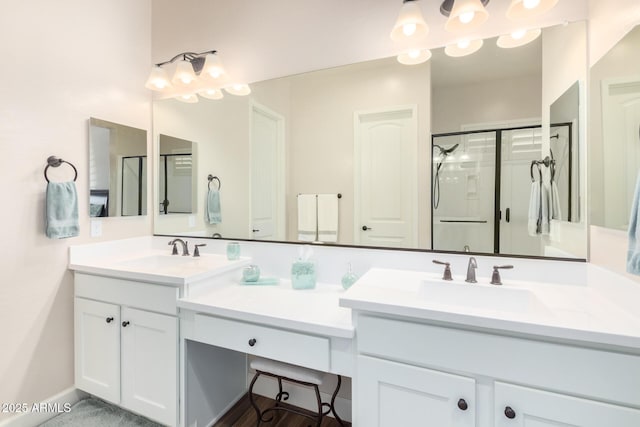 full bathroom with a shower stall and vanity