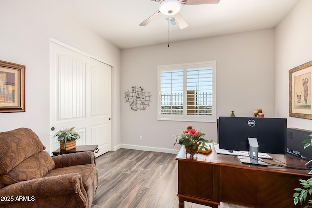office space featuring a ceiling fan, wood finished floors, and baseboards