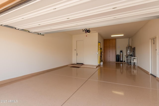 garage featuring a garage door opener, water heater, and baseboards