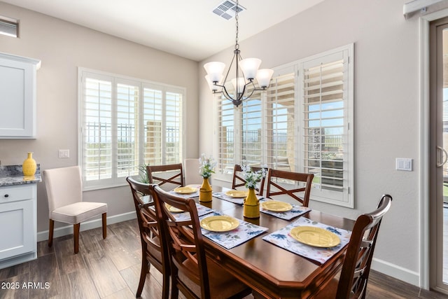dining space with a chandelier, baseboards, and dark wood-style floors