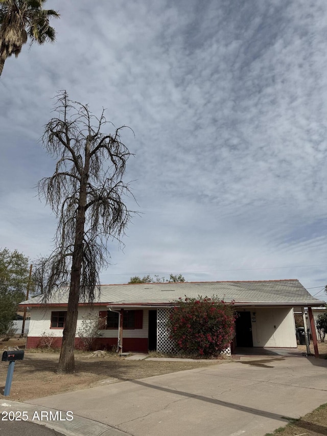 single story home with driveway and an attached carport