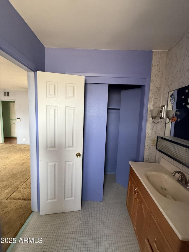 bathroom featuring visible vents, vanity, and tile patterned floors