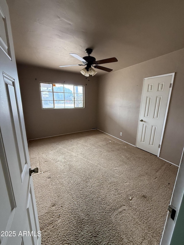 unfurnished bedroom featuring a ceiling fan, carpet flooring, and baseboards