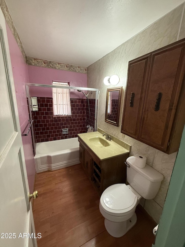 full bath with vanity, tub / shower combination, wood finished floors, and toilet