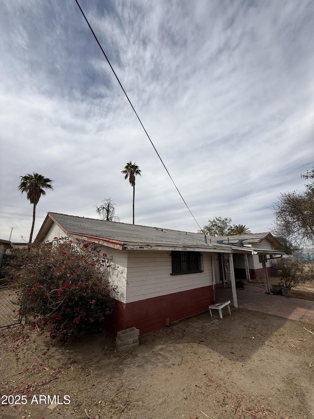 view of side of property with concrete block siding