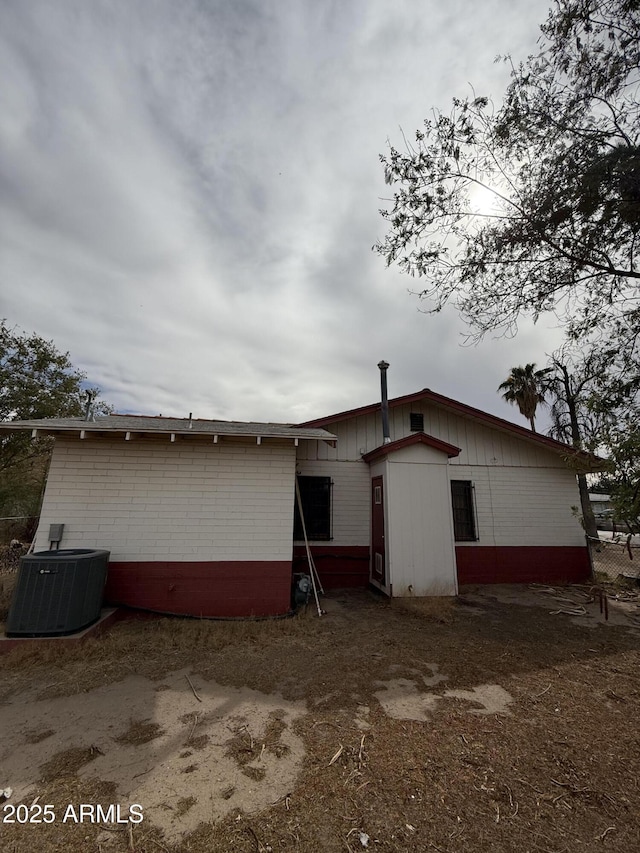 rear view of property featuring cooling unit