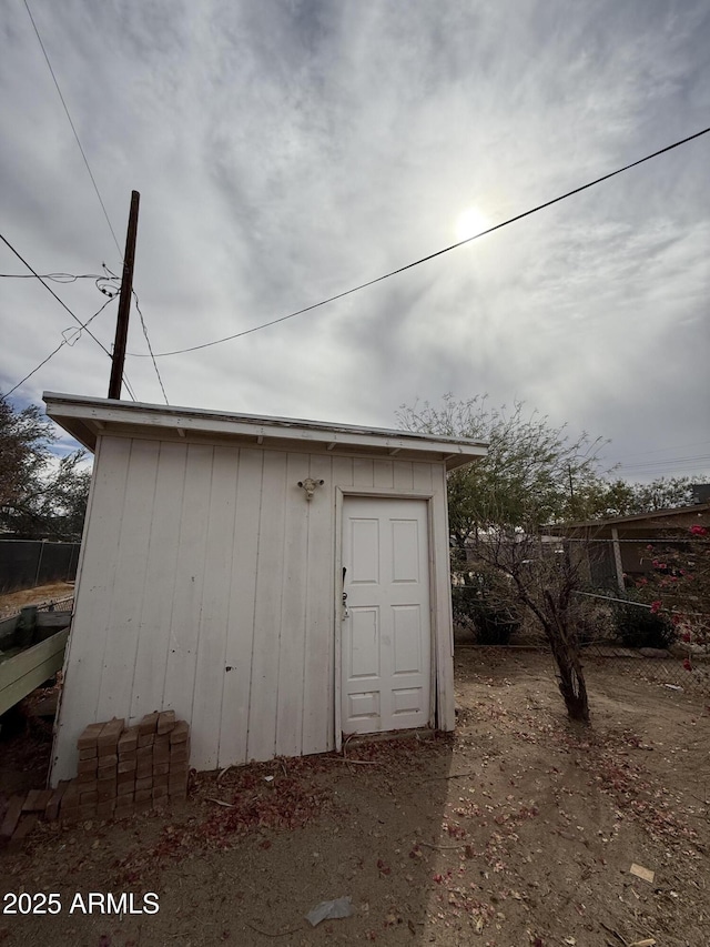 view of shed with fence