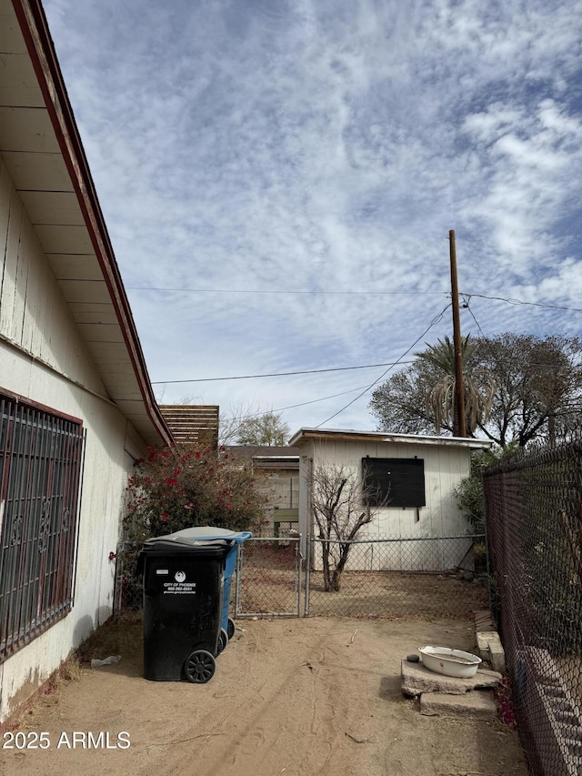 view of home's exterior featuring fence and a gate