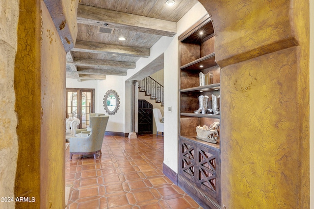 hall featuring french doors, beamed ceiling, wooden ceiling, and tile patterned flooring