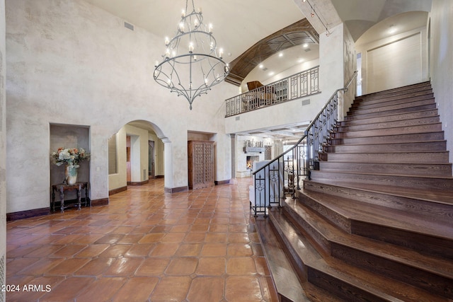 foyer with dark tile patterned floors and a high ceiling