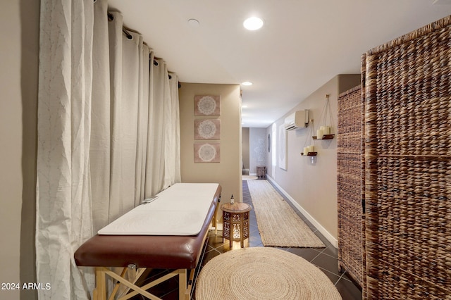 hall featuring a wall mounted AC and dark tile patterned floors