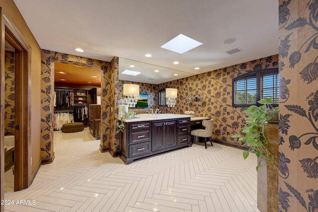 bathroom featuring vanity, parquet floors, and a skylight