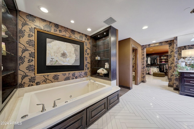 bathroom with vanity and a washtub