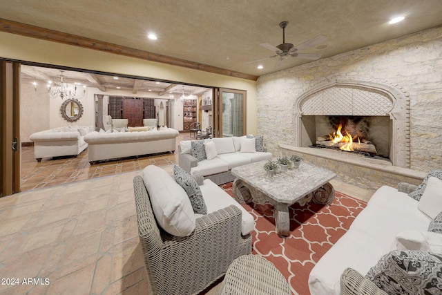 living room with ceiling fan with notable chandelier