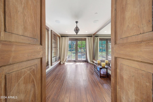 interior space with ornamental molding, french doors, and dark hardwood / wood-style flooring