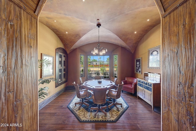 dining area featuring vaulted ceiling, a chandelier, and dark hardwood / wood-style floors