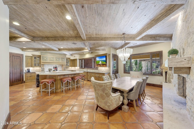 tiled dining area featuring sink, a fireplace, wooden ceiling, beam ceiling, and an inviting chandelier