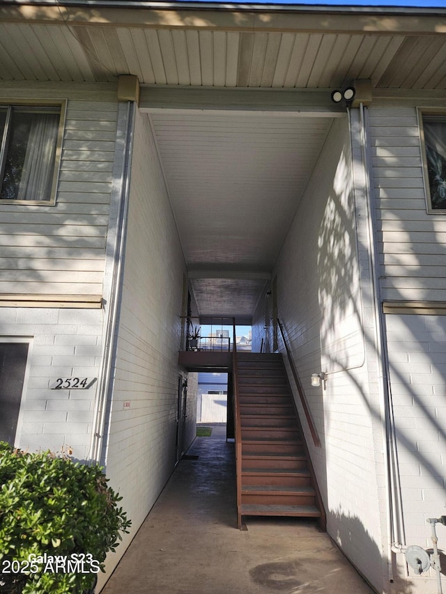 doorway to property featuring brick siding