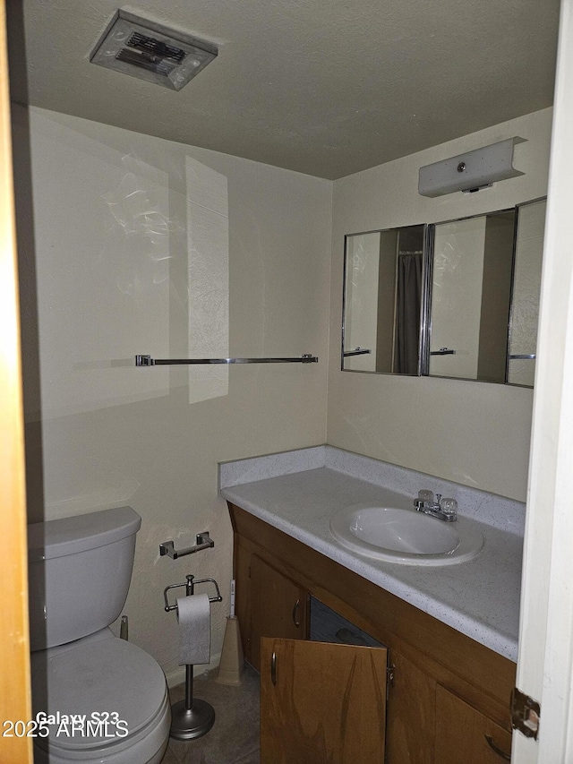 full bathroom featuring vanity, toilet, and visible vents