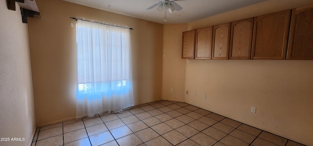 empty room featuring ceiling fan and light tile patterned flooring