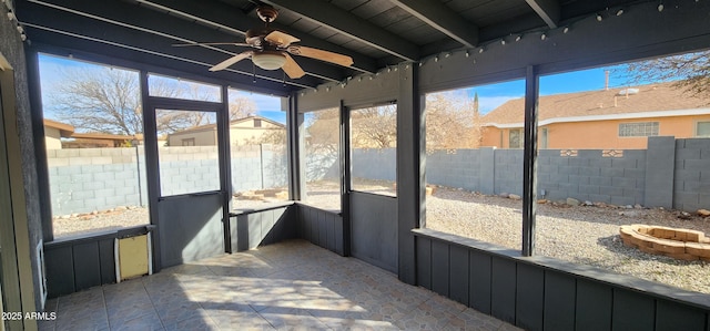 sunroom featuring wood ceiling, ceiling fan, beamed ceiling, and a healthy amount of sunlight