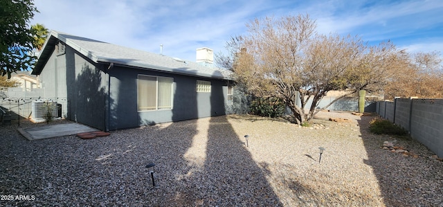 back of house featuring central AC