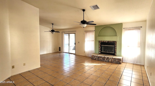 unfurnished living room featuring ceiling fan and light tile patterned floors