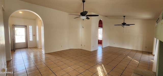 empty room with light tile patterned floors and ceiling fan