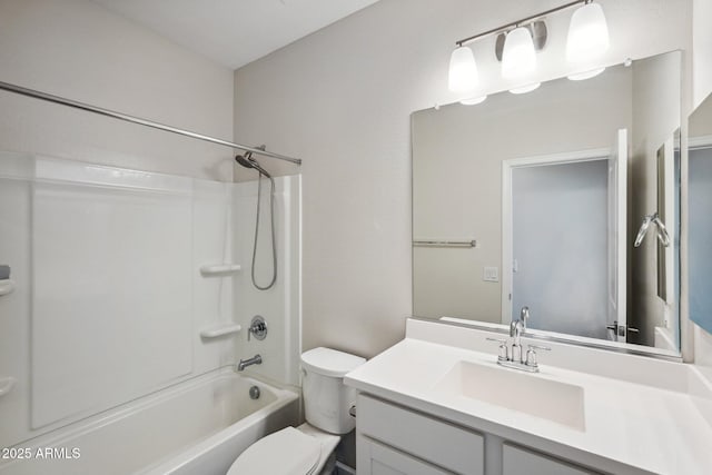 bathroom featuring toilet, shower / bathing tub combination, and vanity