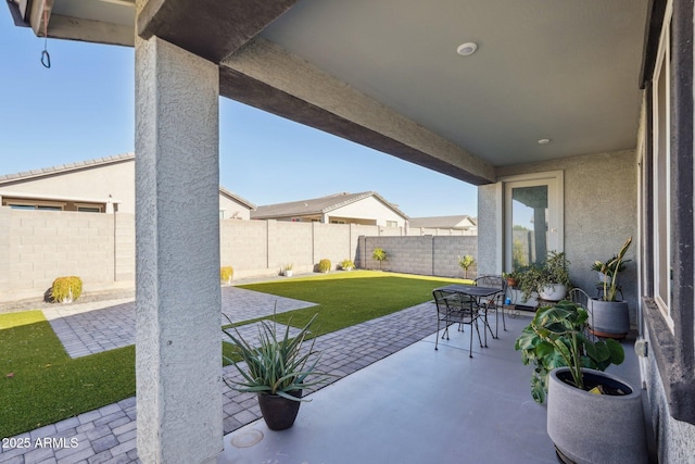 view of patio with outdoor dining area and a fenced backyard