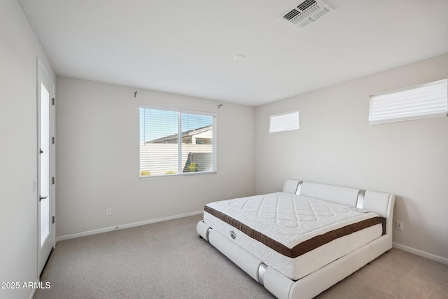 bedroom featuring light carpet, baseboards, and visible vents