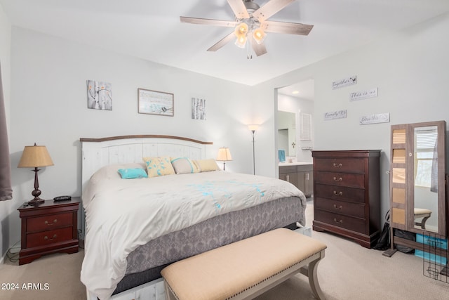 carpeted bedroom featuring ensuite bath and ceiling fan