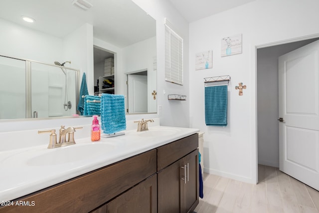 bathroom featuring vanity, hardwood / wood-style flooring, and walk in shower