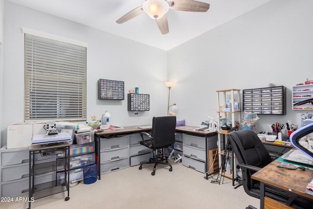 carpeted office featuring ceiling fan