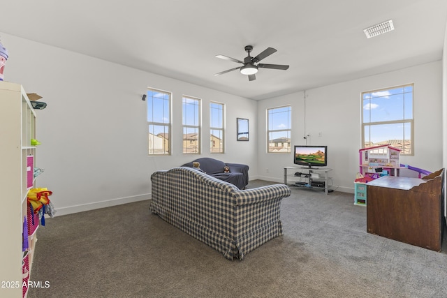 carpeted living area featuring visible vents, baseboards, and ceiling fan