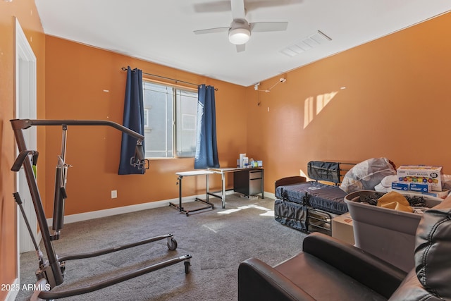 workout room with a ceiling fan, baseboards, visible vents, and carpet floors