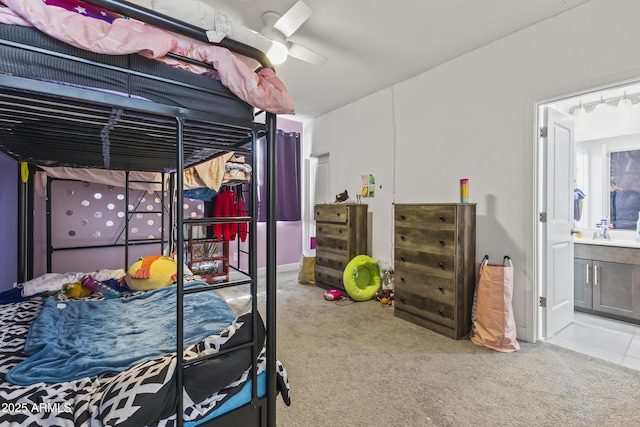 bedroom featuring a sink, ensuite bath, and carpet floors