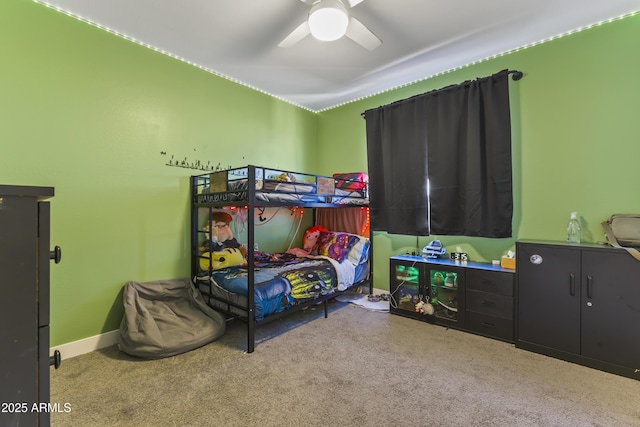 bedroom with baseboards, carpet floors, and a ceiling fan