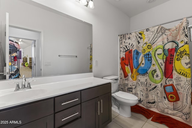 bathroom featuring tile patterned flooring, toilet, and vanity