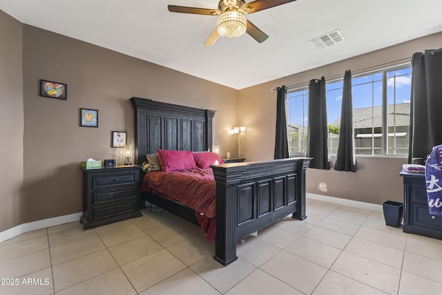 bedroom featuring a ceiling fan, light tile patterned floors, baseboards, and visible vents