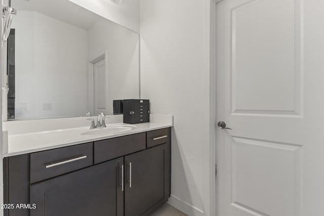 bathroom featuring baseboards and vanity