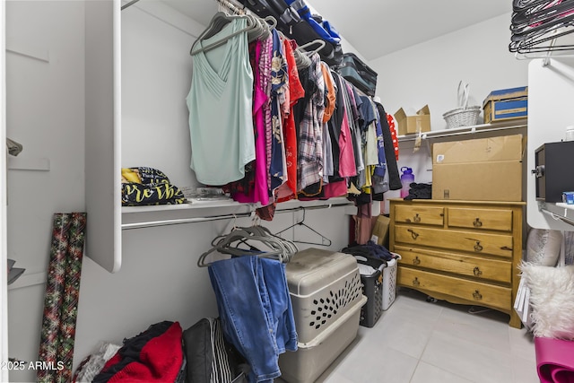 walk in closet with tile patterned floors