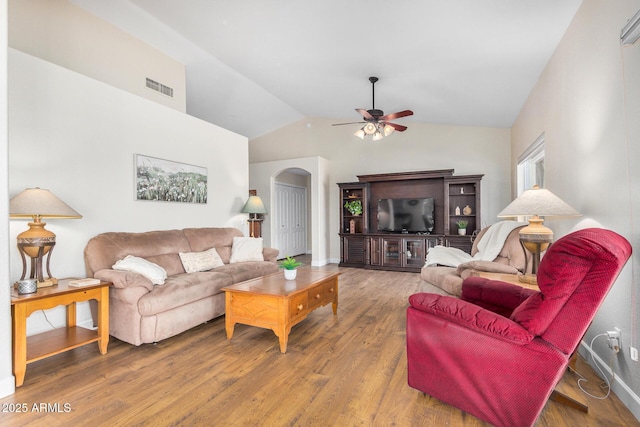 living room with ceiling fan, lofted ceiling, and hardwood / wood-style floors