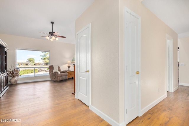 hallway with hardwood / wood-style floors