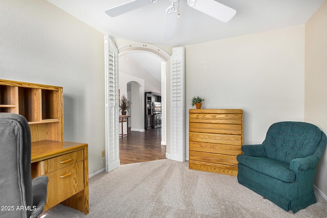 living area featuring ceiling fan and carpet flooring